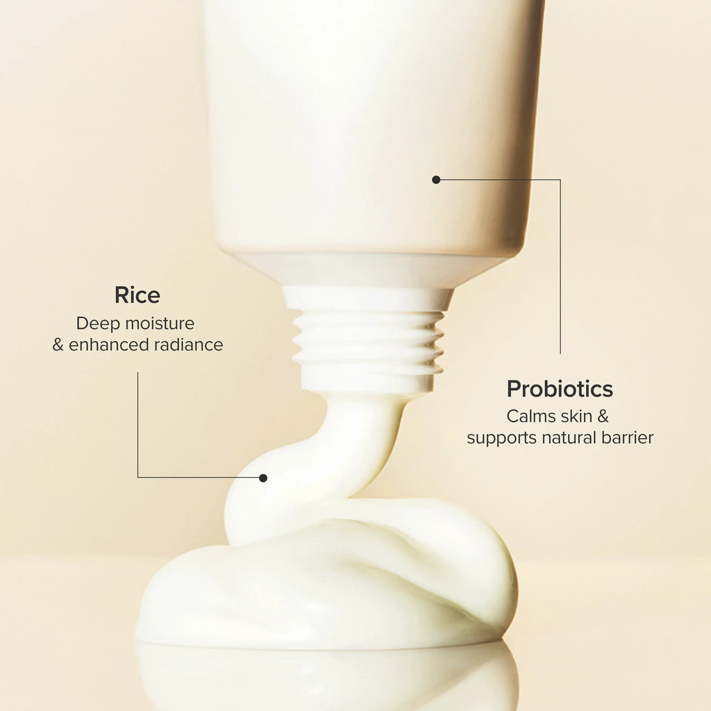 Skincare product with text highlighting rice and probiotics on a beige background